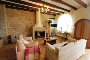 a living room with two couches and a fireplace at "Dobela Enea" Cueva alojamiento privado in Laguardia