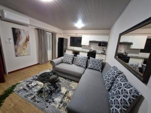 a living room with a couch and a table at Gaborone Platinum Self Catering in Gaborone
