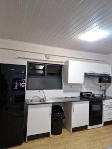 a kitchen with a sink and a stove at Gaborone Platinum Self Catering in Gaborone +5 photos