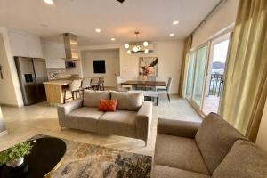 a living room with a couch and a dining room at Spacious Central Apartment, Pool & Gym, Group Friendly in Hermosillo