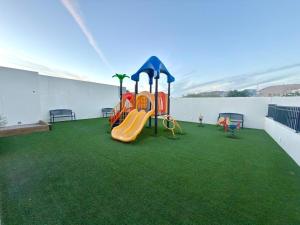 a playground on the roof of a building with green grass at Spacious Central Apartment, Pool & Gym, Group Friendly in Hermosillo