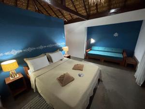 a bedroom with a bed and a bench in a room at Pousada Lanea Experience in Atins +111 photos