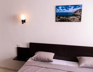Postel nebo postele na pokoji v ubytování Hotel Métropole Résidence