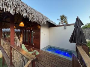 a villa with a deck and a swimming pool at Pousada Lanea Experience in Atins