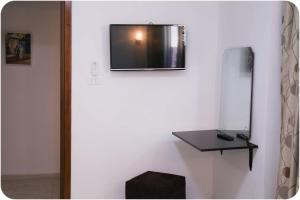 TV a/nebo společenská místnost v ubytování Hotel Métropole Résidence