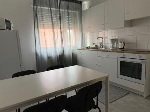 a kitchen with a table and chairs in it at Ferienwohnung Rheinglück in Oppenheim +14 photos
