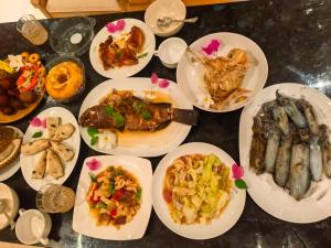 a bunch of plates of food on a table at Jay Guest House Gili Gede in Sekotong