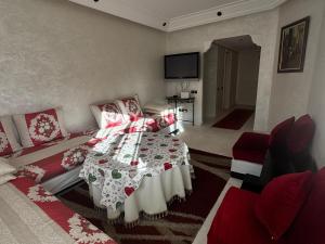 a living room with a bed and a couch at Al ATLAS résidence in Marrakesh
