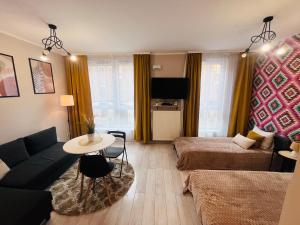 a living room with a couch and a table at Apartamenty Brzeska 10 in Warsaw