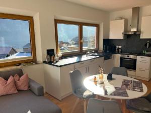 a kitchen with a table and some chairs and a table at Alpenlodge in Wenns