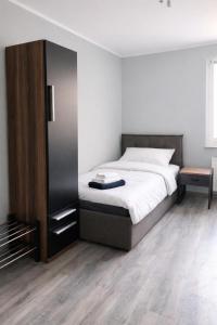 a bedroom with a bed and a wooden floor at Apartments in Leuna in Leuna