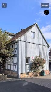 a large white building with a window on it at Good N8 Apartment in Wabern