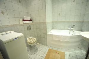a white bathroom with a toilet and a sink at Apartament Tais in Wrocław