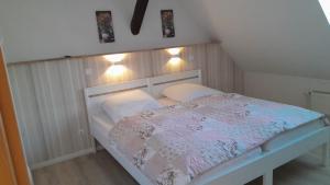 a bed in a room with two pillows at Apartmenthaus Rosenflair in Schönebeck