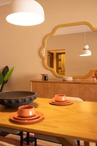 a dining room with a table with a mirror at Villette Serviced Apartments in Sodic New Cairo in New cairo