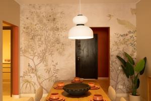 a dining room with a table and a black door at Villette Serviced Apartments in Sodic New Cairo in New cairo +93 photos