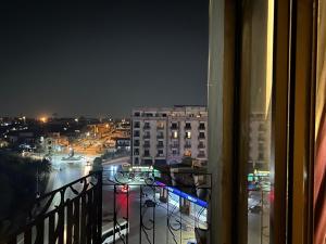 a view of a city at night from a balcony at Prime Stays Rezidor in Rawalpindi
