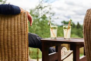 a table with two glasses on top of it at Boutique Hotel SwissHouse in Mariánské Lázně