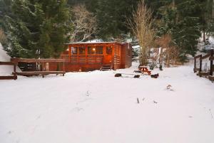 an orange cabin in a snow covered yard at Chata Bella Donovaly in Donovaly +2 photos
