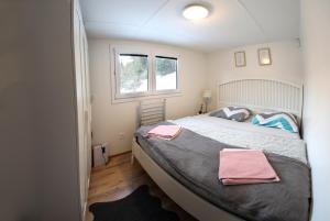 a bedroom with a bed with two towels on it at Chata Bella Donovaly in Donovaly