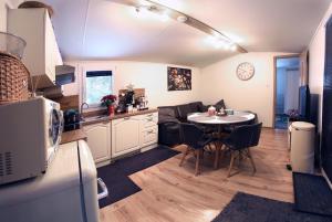 a kitchen and dining room with a table in a kitchen at Chata Bella Donovaly in Donovaly