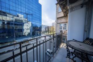 a balcony with a table and a view of a street at 49 Park Villa in Belgrade