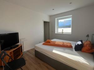 a bedroom with a bed and a flat screen tv at Ferienwohnung Wanderlust in Marsberg