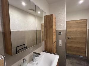 a bathroom with a sink and a mirror at Ferienwohnung Wanderlust in Marsberg +26 photos