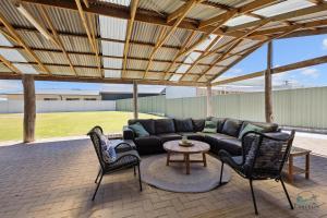 a patio with a couch and chairs and a table at Sea Chain in Lancelin