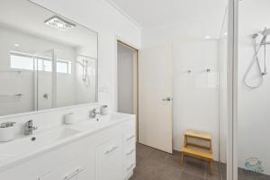 a white bathroom with a sink and a shower at Sea Chain in Lancelin +23 photos