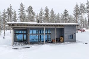 a small house in the snow with trees at Arctic Villas Ruka in Kuusamo