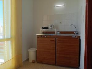 a small kitchen with a sink and a microwave at on the STRIP-Studio 2 in Kavos