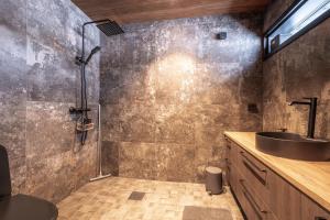 a bathroom with a sink and a shower at Arctic Villas Ruka in Kuusamo