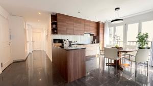 a kitchen with a table and a dining room at Center Park Apartment in Interlaken