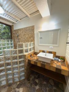 a bathroom with a sink and a mirror at Conchy Tonk in Bocas Town +104 photos