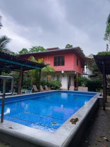 a swimming pool in front of a house at Conchy Tonk in Bocas Town