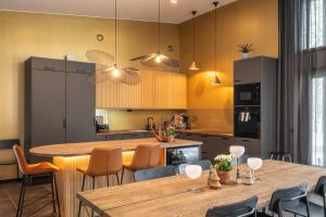 a kitchen with a large wooden table and chairs at Arctic Villas Ruka in Kuusamo +27 photos