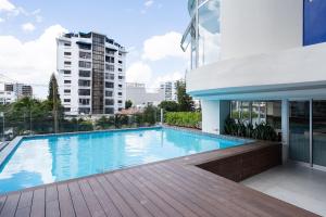 a swimming pool on a balcony of a building at Shalom Suites by Yellowkey in Santo Domingo