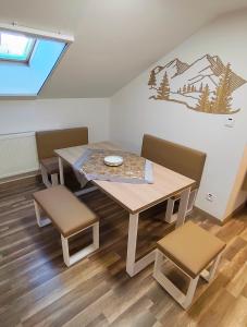 a dining room with a table and two chairs at Apartmán Altis in Tatranska Strba