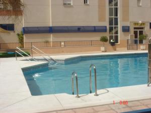 a large swimming pool in a large building at Apartamento Paraiso Sol in Torrox Costa