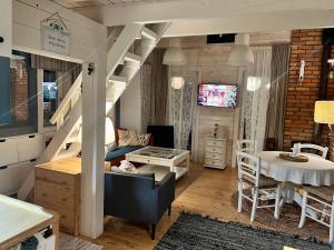 a living room with a staircase and a table at Domki nad morzem Sasino Mojo Miodno Checz in Sasino