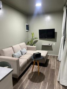 a living room with a couch and a tv at FelTix container loft in Sabakoe