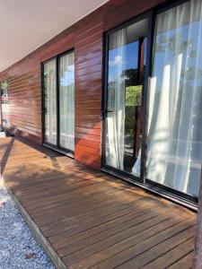 a wooden deck with windows on a house at FelTix container loft in Sabakoe