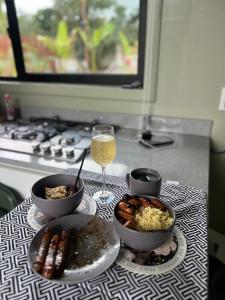 a table with bowls of food and a glass of wine at FelTix container loft in Sabakoe