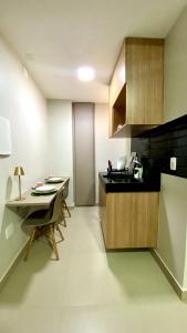 a kitchen with a small table and a counter top at Dom Carlos in Belém
