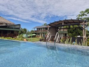 a swimming pool in front of a house with a swimming pool at Dani's Guesthouse in Las Galeras