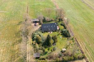 an aerial view of a black house in a field at Haus Birkenhof in Moorhausen