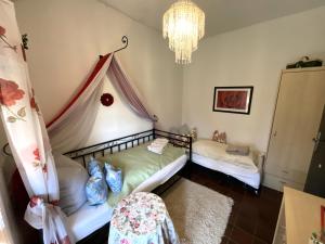 a bedroom with two beds and a chandelier at Haus Birkenhof in Moorhausen