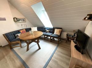 a living room with a couch and a table at Haus Birkenhof in Moorhausen