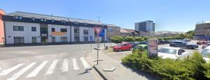 a parking lot with cars parked in front of a building at Apartman SPORKA in Púchov